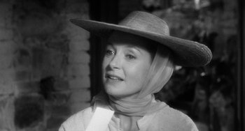 Movie still from “The Night of the Iguana” (1964), directed by John Huston – A black and white photo of a woman wearing a cowboy hat; Close Up shot, Low angle