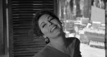 Movie still from “The Night of the Iguana” (1964), directed by John Huston – A black - and - white photo of a woman laughing; Close Up shot, Low angle