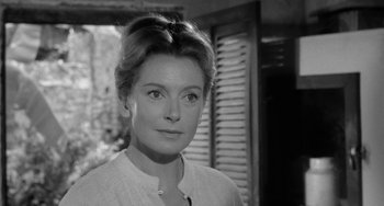 Movie still from “The Night of the Iguana” (1964), directed by John Huston – Black and white photograph of a woman in front of a window; Close Up shot, Over the shoulder angle
