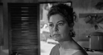 Movie still from “The Night of the Iguana” (1964), directed by John Huston – Black and white photograph of a woman looking at the camera; Close Up shot, Over the shoulder angle