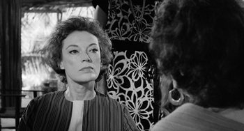 Movie still from “The Night of the Iguana” (1964), directed by John Huston – An older woman looking into a mirror while standing next to another woman; Close Up shot, Over the shoulder angle