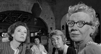 Movie still from “The Night of the Iguana” (1964), directed by John Huston – A black and white photo of a group of people; Close Up shot, Low angle