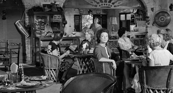 Movie still from “The Night of the Iguana” (1964), directed by John Huston – A group of women sitting at a table in a restaurant; Wide shot, High angle