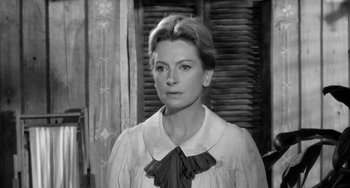 Movie still from “The Night of the Iguana” (1964), directed by John Huston – Black and white photograph of a woman in a white dress; Close Up shot, Low angle
