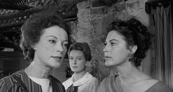 Movie still from “The Night of the Iguana” (1964), directed by John Huston – A group of women standing next to each other in front of a brick wall; Close Up shot, Over the shoulder angle