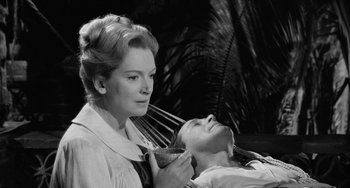Movie still from “The Night of the Iguana” (1964), directed by John Huston – An old photo of a woman and a young man; Medium shot, High angle