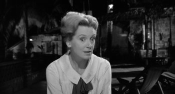 Movie still from “The Night of the Iguana” (1964), directed by John Huston – An old photo of a woman with a surprised look on her face; Close Up shot, High angle