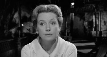 Movie still from “The Night of the Iguana” (1964), directed by John Huston – An old black and white photo of a woman looking at the camera; Close Up shot, Over the shoulder angle