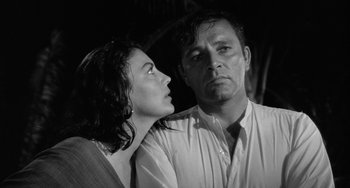 Movie still from “The Night of the Iguana” (1964), directed by John Huston – A man and a woman looking at each other in a black and white photo; Close Up shot, Low angle