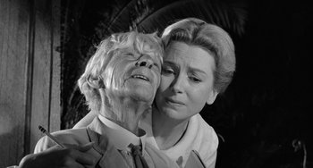 Movie still from “The Night of the Iguana” (1964), directed by John Huston – An older woman and a younger woman embracing each other; Close Up shot, Low angle