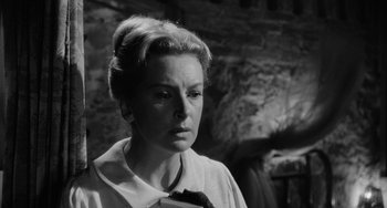 Movie still from “The Night of the Iguana” (1964), directed by John Huston – An old black and white photo of a woman; Close Up shot, Low angle