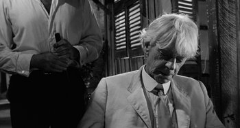 Movie still from “The Night of the Iguana” (1964), directed by John Huston – An older man in a suit and tie; Close Up shot, Over the shoulder angle