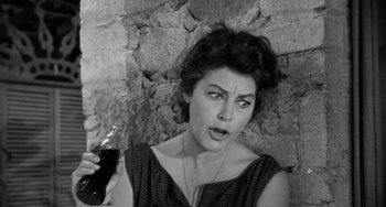 Movie still from “The Night of the Iguana” (1964), directed by John Huston – An old photo of a woman holding a glass of soda; Close Up shot, High angle