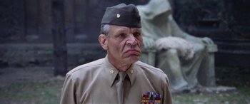 Movie still from “The Ninth Configuration” (1980), directed by William Peter Blatty – An older man in a military uniform looking at the camera; Close Up shot, Low angle