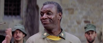 Movie still from “The Ninth Configuration” (1980), directed by William Peter Blatty – An older man wearing a green and yellow shirt; Close Up shot, Low angle