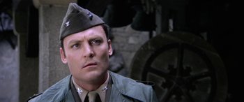 Movie still from “The Ninth Configuration” (1980), directed by William Peter Blatty – A person wearing a uniform; Close Up shot, Low angle