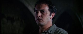 Movie still from “The Ninth Configuration” (1980), directed by William Peter Blatty – A person wearing a shirt; Close Up shot, Low angle