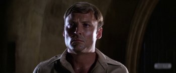 Movie still from “The Ninth Configuration” (1980), directed by William Peter Blatty – A person wearing a shirt; Close Up shot, Low angle