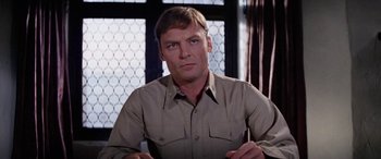 Movie still from “The Ninth Configuration” (1980), directed by William Peter Blatty – A person sitting in a chair; Close Up shot, Low angle