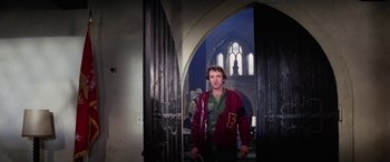 Movie still from “The Ninth Configuration” (1980), directed by William Peter Blatty – A man standing in front of an open church door; Medium shot, Low angle