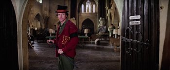 Movie still from “The Ninth Configuration” (1980), directed by William Peter Blatty – A man wearing a top hat holding a whip; Medium shot, Low angle