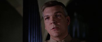 Movie still from “The Ninth Configuration” (1980), directed by William Peter Blatty – A person wearing a uniform looking at the camera; Close Up shot, Low angle