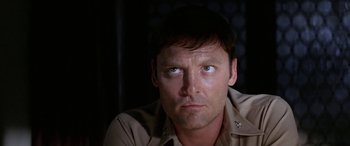 Movie still from “The Ninth Configuration” (1980), directed by William Peter Blatty – A person looking at the camera; Close Up shot, Low angle