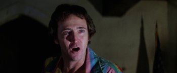 Movie still from “The Ninth Configuration” (1980), directed by William Peter Blatty – A person wearing a rainbow shirt; Close Up shot, Low angle