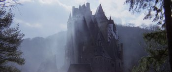 Movie still from “The Ninth Configuration” (1980), directed by William Peter Blatty – A large castle with smoke coming out of it's windows; Extreme Wide shot, Low angle