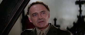 Movie still from “The Ninth Configuration” (1980), directed by William Peter Blatty – An older man in a military uniform looking at the camera; Close Up shot, Low angle