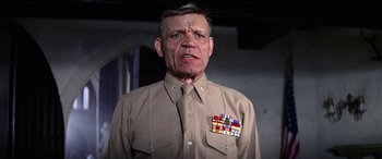 Movie still from “The Ninth Configuration” (1980), directed by William Peter Blatty – An older man wearing a uniform with medals around his neck; Close Up shot, Low angle