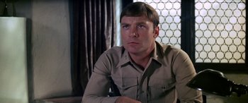 Movie still from “The Ninth Configuration” (1980), directed by William Peter Blatty – A person sitting in a chair; Close Up shot, Low angle