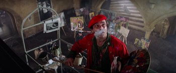 Movie still from “The Ninth Configuration” (1980), directed by William Peter Blatty – A man in a red jacket is smoking a cigarette; Medium shot, Low angle