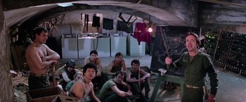Movie still from “The Ninth Configuration” (1980), directed by William Peter Blatty – A group of young men sitting next to each other; Wide shot, High angle