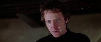 Movie still from “The Ninth Configuration” (1980), directed by William Peter Blatty – A person wearing a black shirt; Close Up shot, Low angle