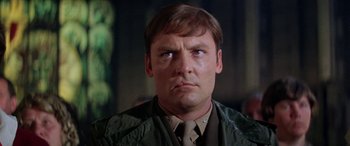 Movie still from “The Ninth Configuration” (1980), directed by William Peter Blatty – A person wearing a jacket; Close Up shot, Low angle