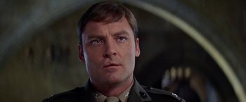 Movie still from “The Ninth Configuration” (1980), directed by William Peter Blatty – A person wearing a military uniform; Close Up shot, Low angle