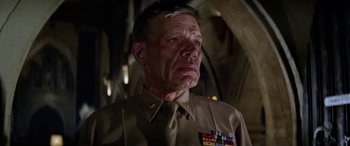 Movie still from “The Ninth Configuration” (1980), directed by William Peter Blatty – An older man wearing a military uniform and medals; Close Up shot, Low angle