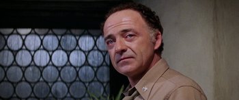 Movie still from “The Ninth Configuration” (1980), directed by William Peter Blatty – A person wearing a shirt; Close Up shot, Low angle