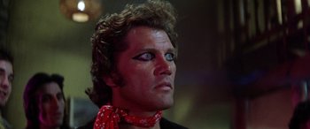Movie still from “The Ninth Configuration” (1980), directed by William Peter Blatty – A person wearing makeup and a bandanna; Close Up shot, Low angle