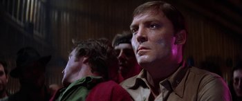 Movie still from “The Ninth Configuration” (1980), directed by William Peter Blatty – A group of men standing next to each other in a room; Close Up shot, Low angle