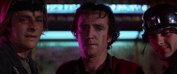 Movie still from “The Ninth Configuration” (1980), directed by William Peter Blatty – A person wearing a green shirt; Close Up shot, Low angle