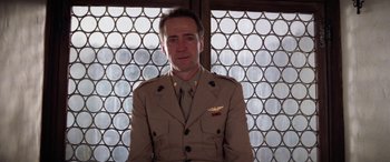 Movie still from “The Ninth Configuration” (1980), directed by William Peter Blatty – A man in a military uniform standing in front of a window; Medium shot, Low angle