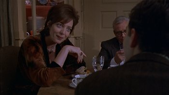 Movie still from “The Object of My Affection” (1998), directed by Nicholas Hytner – A woman sitting at a dinner table with a man; Medium shot, Over the shoulder angle