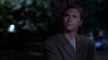 Movie still from “The Object of My Affection” (1998), directed by Nicholas Hytner – A man in a suit looking up at a tree; Close Up shot, Low angle