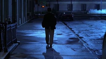 A man walking down a street at night