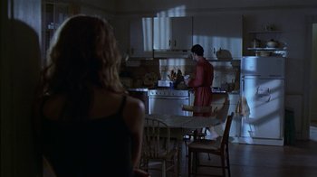 Movie still from “The Object of My Affection” (1998), directed by Nicholas Hytner – Two women are in a kitchen preparing a meal; Wide shot, Over the shoulder angle