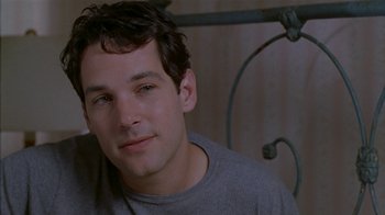 Movie still from “The Object of My Affection” (1998), directed by Nicholas Hytner – A person sitting in front of a bed; Close Up shot, Over the shoulder angle