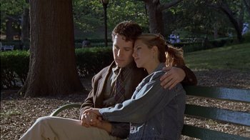 Movie still from “The Object of My Affection” (1998), directed by Nicholas Hytner – A man and a woman sitting on a park bench; Medium shot, High angle