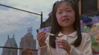Movie still from “The Object of My Affection” (1998), directed by Nicholas Hytner – A little girl holding a glass of water and a toothbrush; Close Up shot, High angle